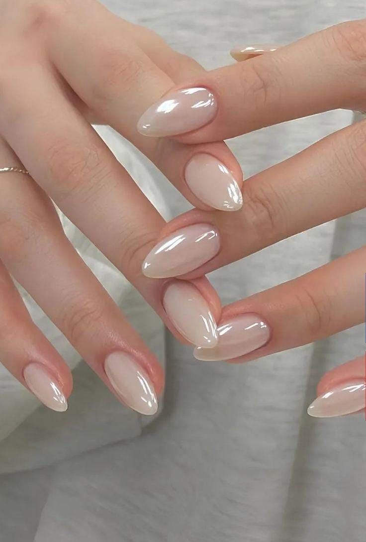 Glazed donut nails with a shiny pearl finish inspired by Hailey Bieber