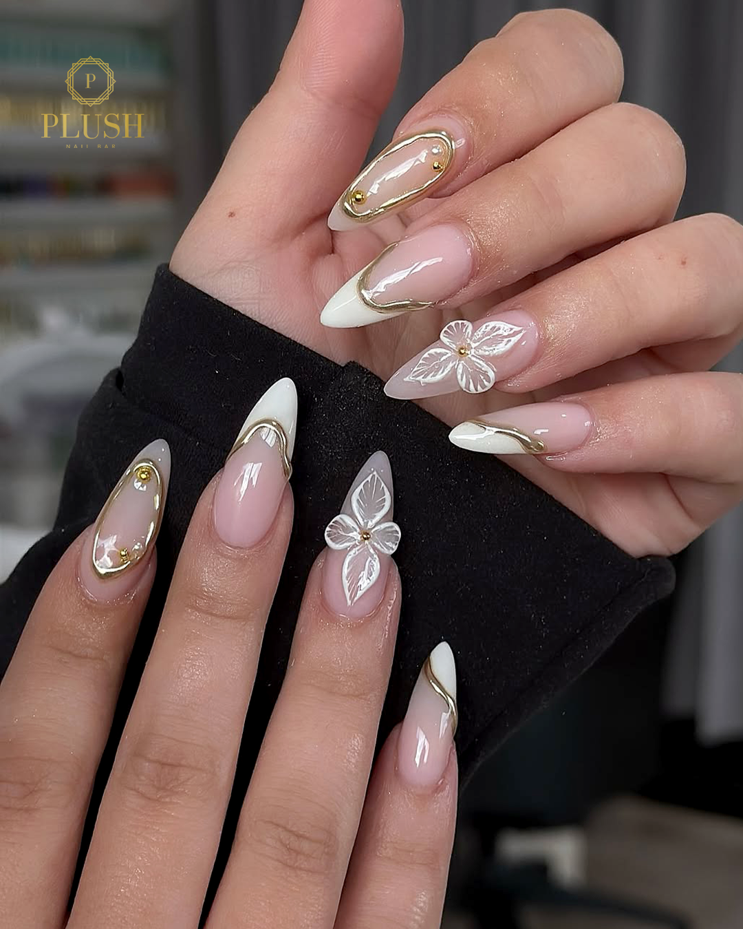 Top 9 Trending Nails at Plush Nail Bar You’ll Love Right Now 7 White floral accent nails with 3D flower details, feminine nail art