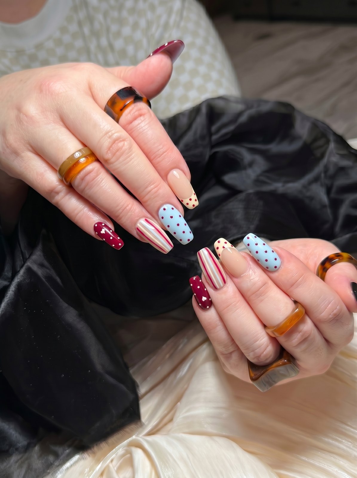 Long square retro nails with powder blue polka dots, red and white candy stripes and cherry hearts