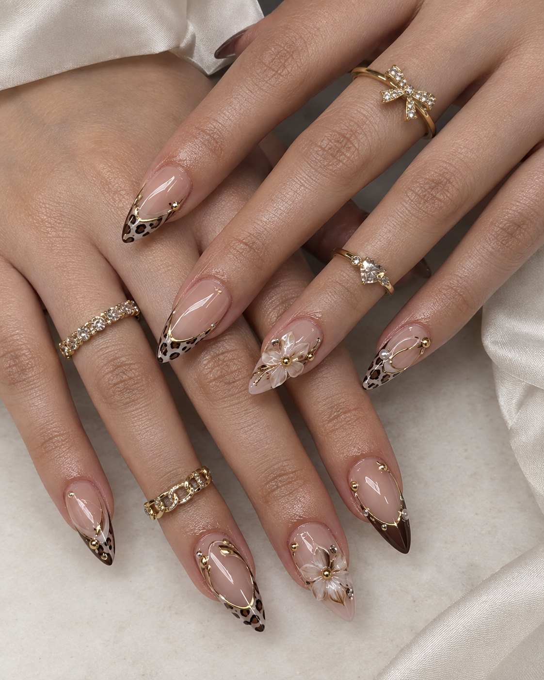 Plaid Nails Bring Sweater Weather Straight to Your Hands 8 Long leopard print French nails with gold chrome accents and white 3D flowers