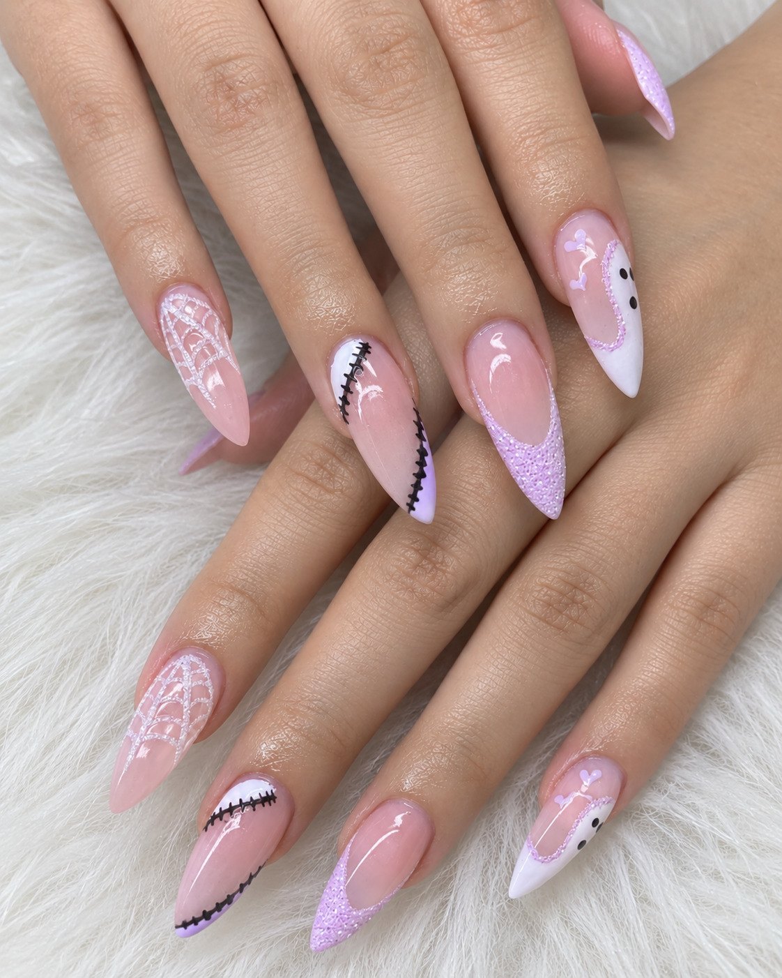 Lilac glitter French almond nails with Frankenstein stitches, sparkly spiderwebs and a ghost tip
