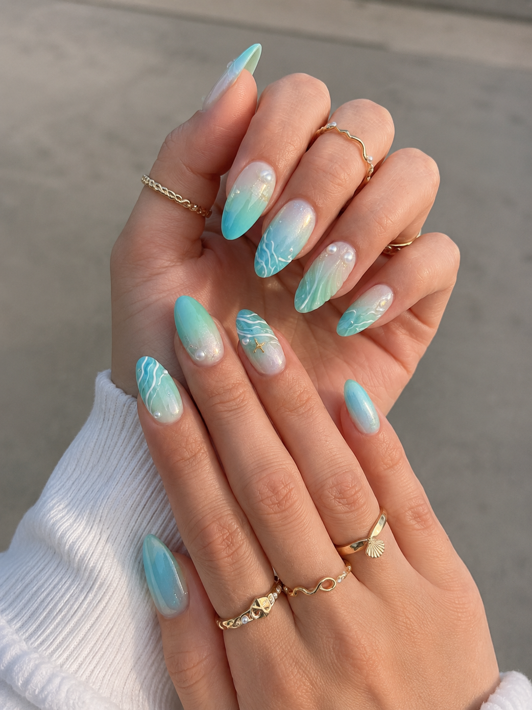 Pearl mermaid nails with coastal beach-inspired design.