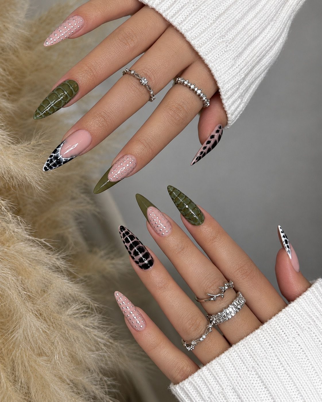 Long stiletto nails with olive 3D croc texture, silver studs and black croc tips
