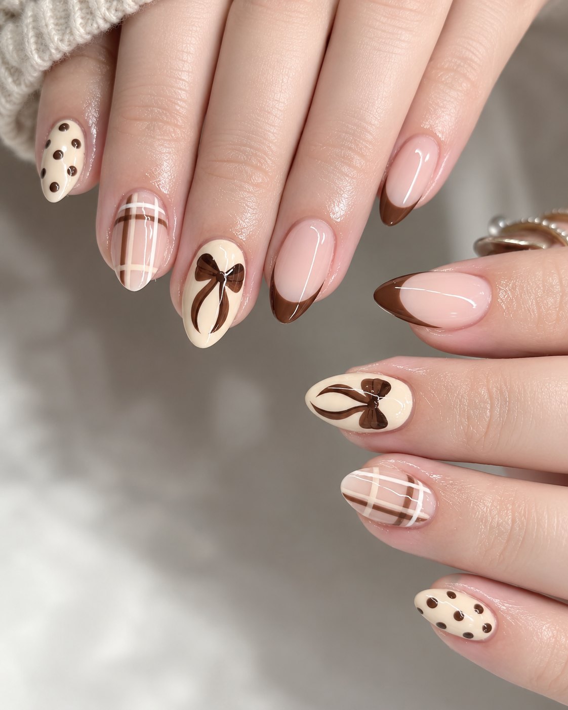Plaid Nails Bring Sweater Weather Straight to Your Hands 2 Cream and brown plaid nails with painted bows, polka dots and chocolate French tips