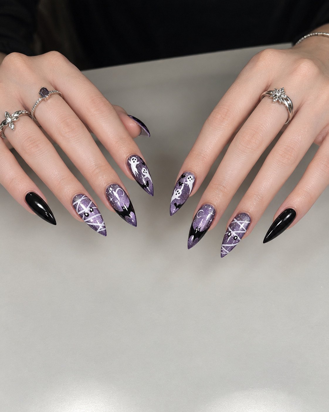 Lavender cat-eye stiletto nails with mummy wraps, ghosts, black bat tips and solid black pinkies