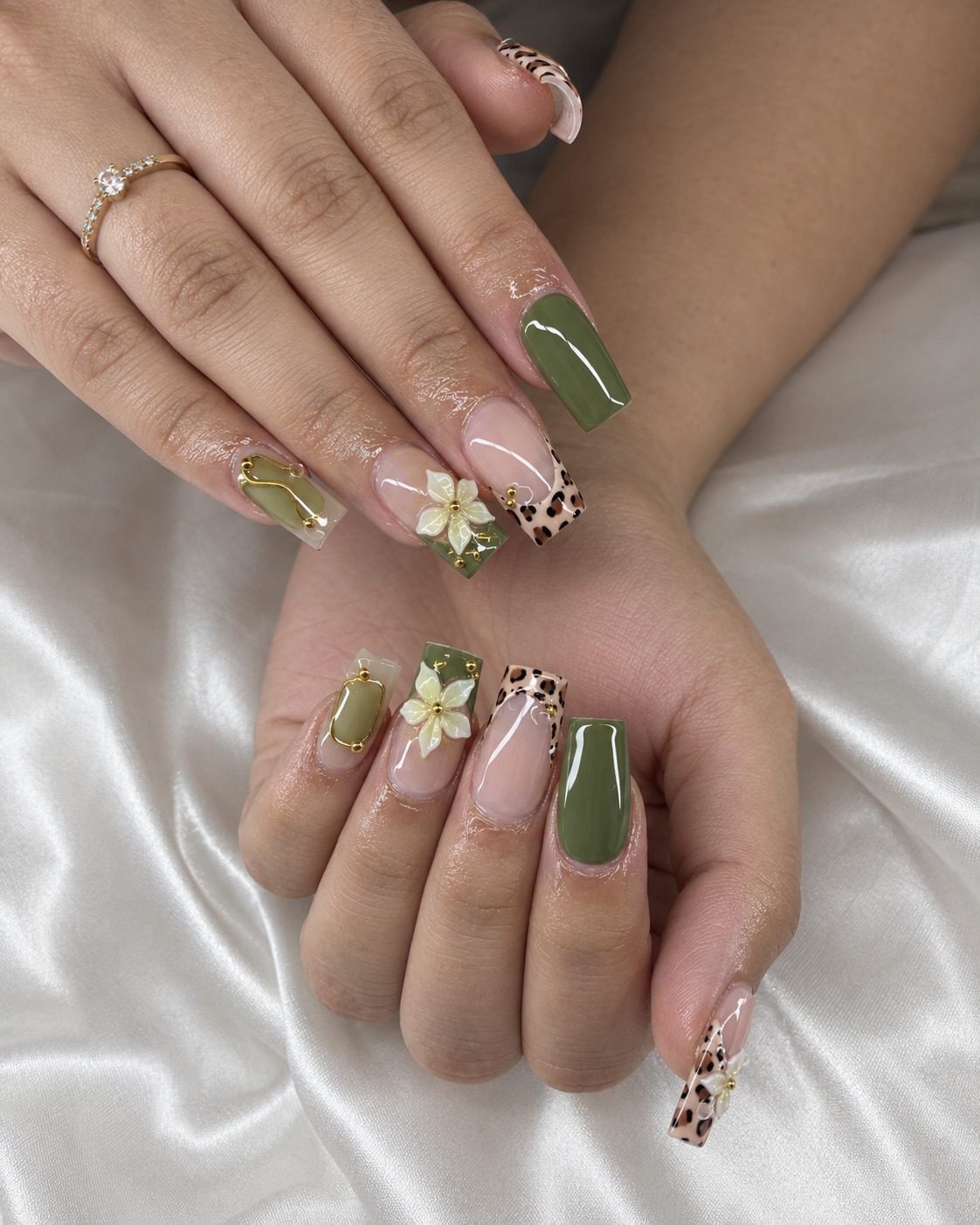 Square olive nails with leopard French tips, a white 3D flower and gold beads