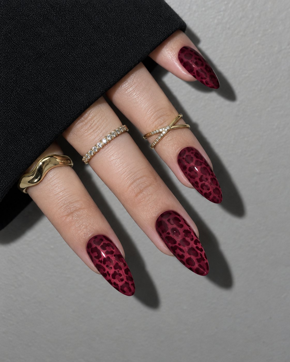 Glossy oxblood almond nails with tonal wine leopard print