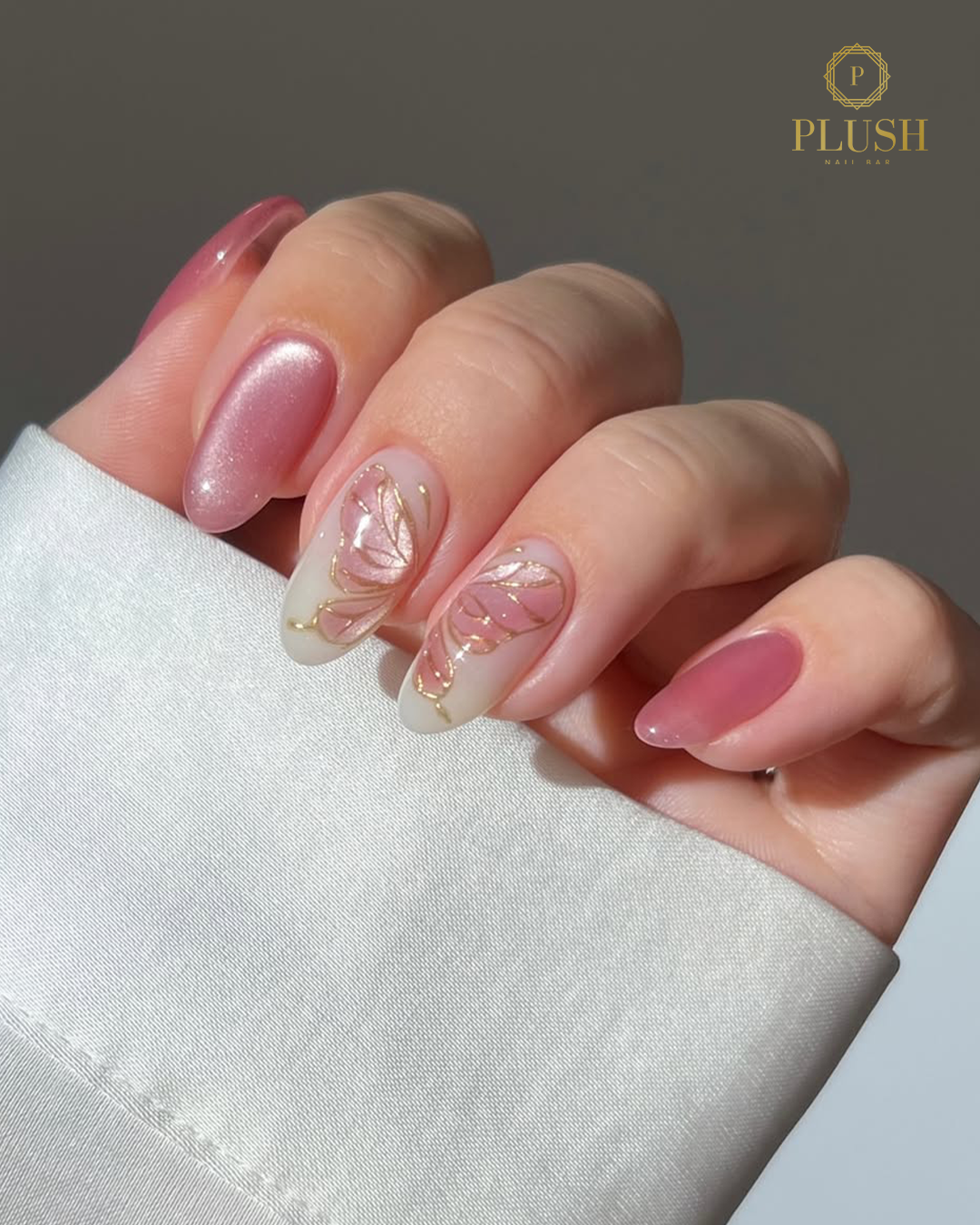 Soft pink valentine nails with gold leaf butterfly design at Plush Nail Bar